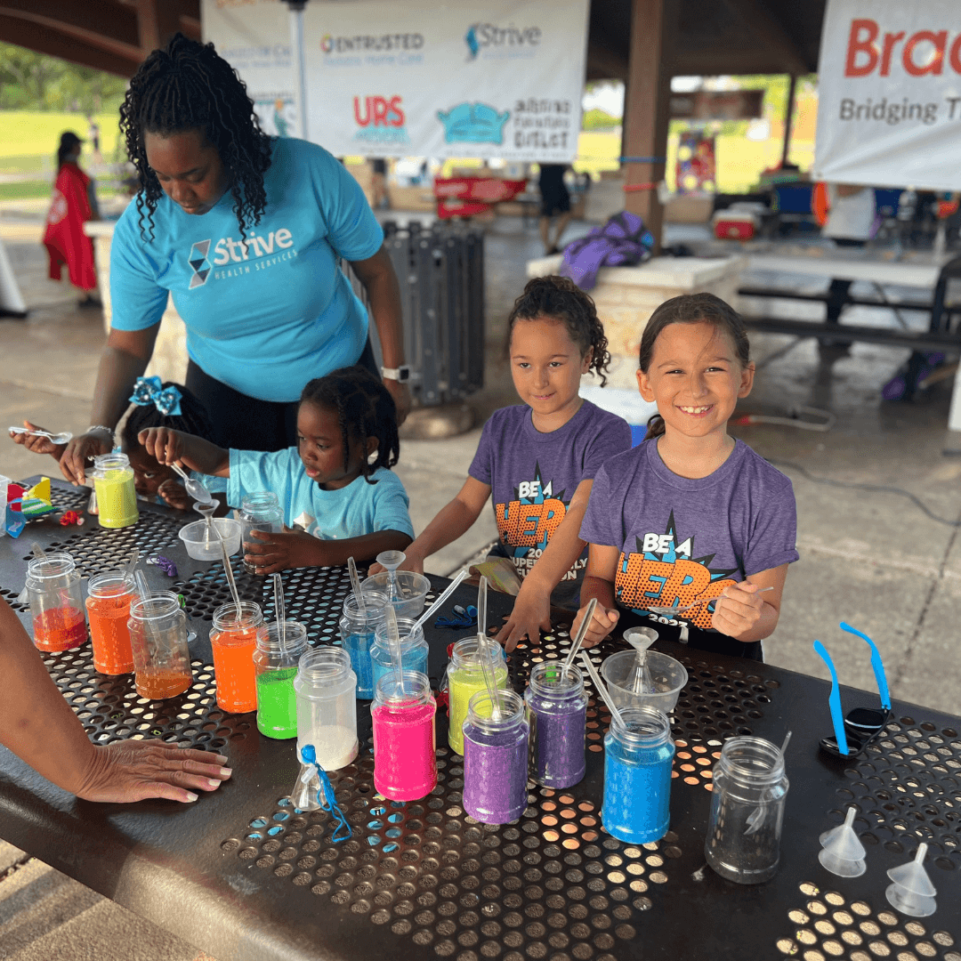 Strive employees and children at a craft table