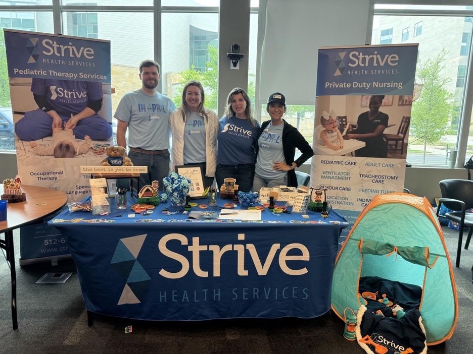 Strive employees working at an event booth