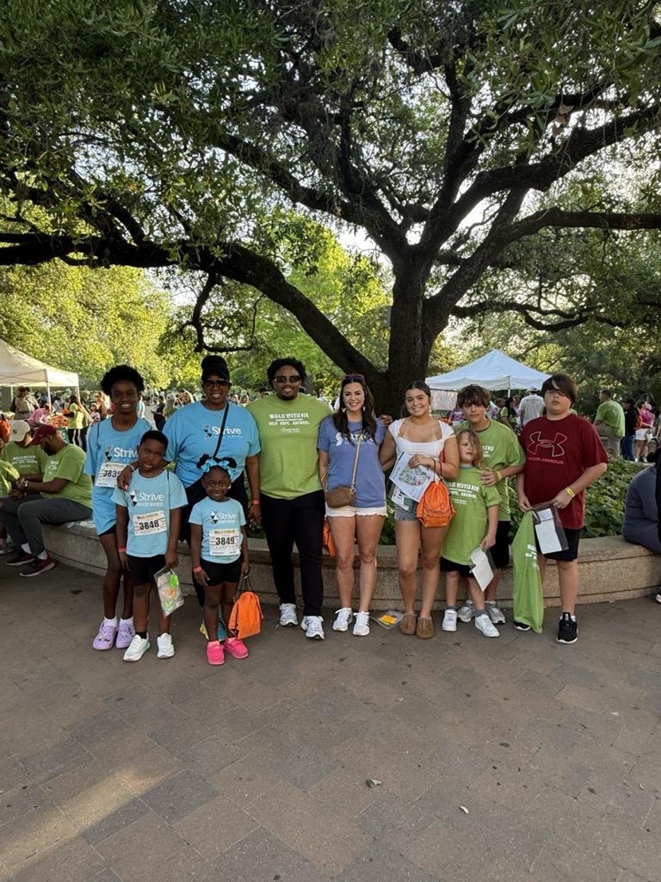 Strive employees and children at an outdoor event