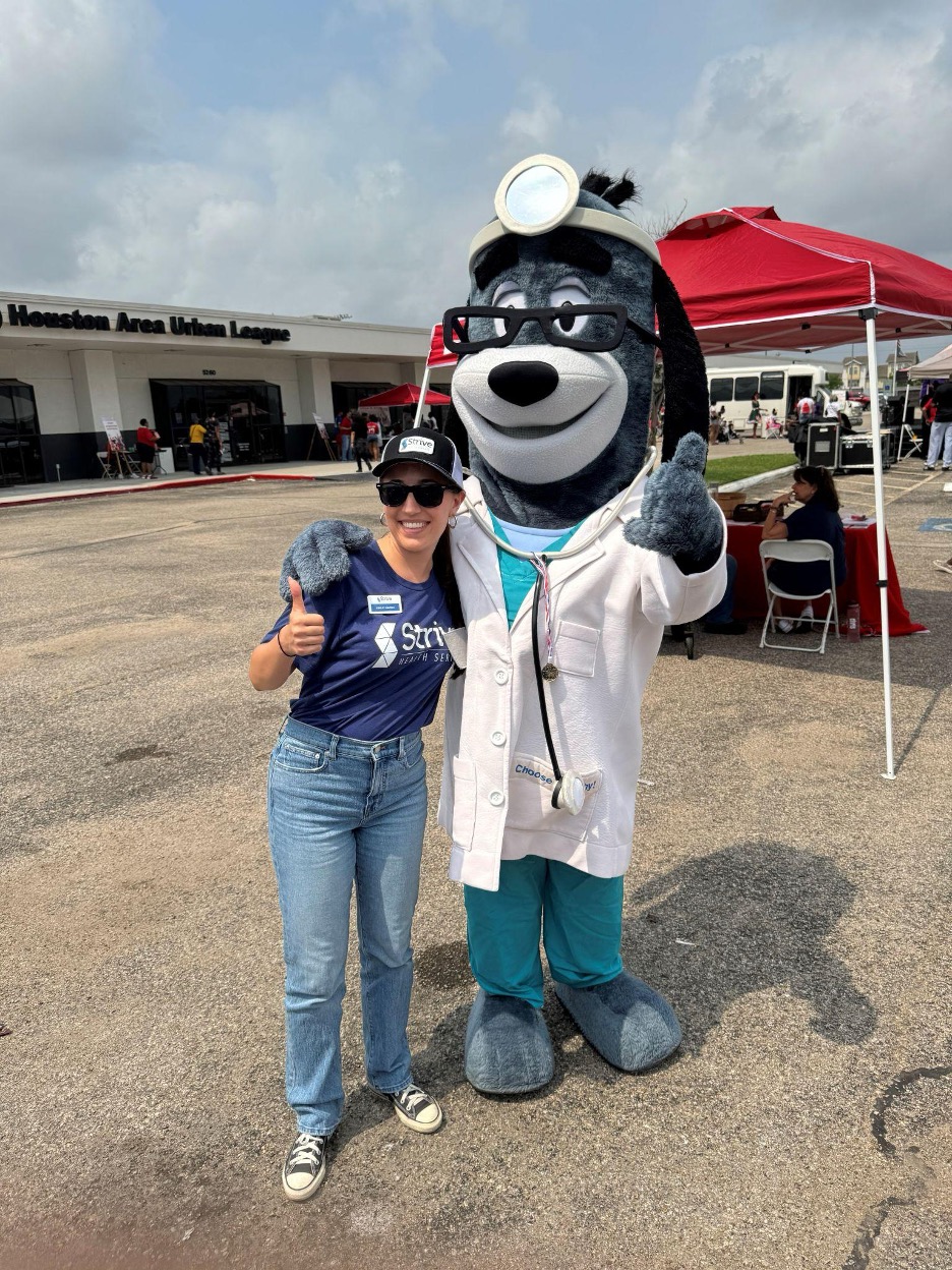 Strive employees with dog mascot