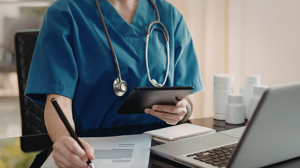 Clinician working on insurance paperwork